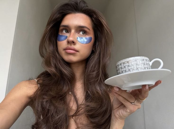  Woman relaxing peacefully at home while practicing self-care through journaling, tea, and mindfulness, representing wellness beyond bubble baths.
