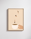 Framed artwork of a coffee cup with hands and droplets on a beige background