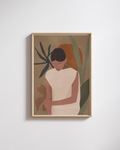Framed artwork of a person with plants on a light gray wall