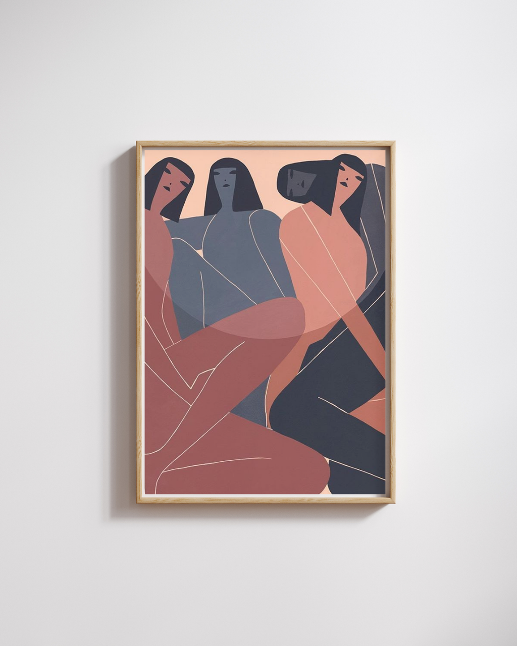 Framed abstract artwork of three figures on a white wall